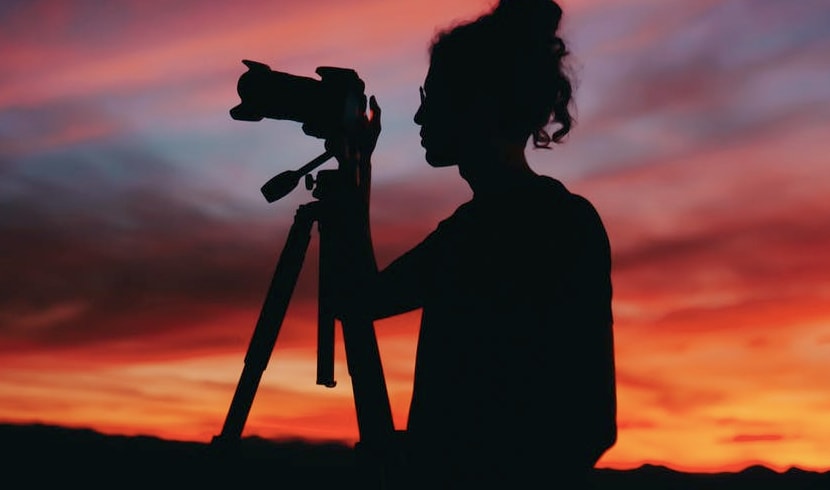 Woman with camera at suset